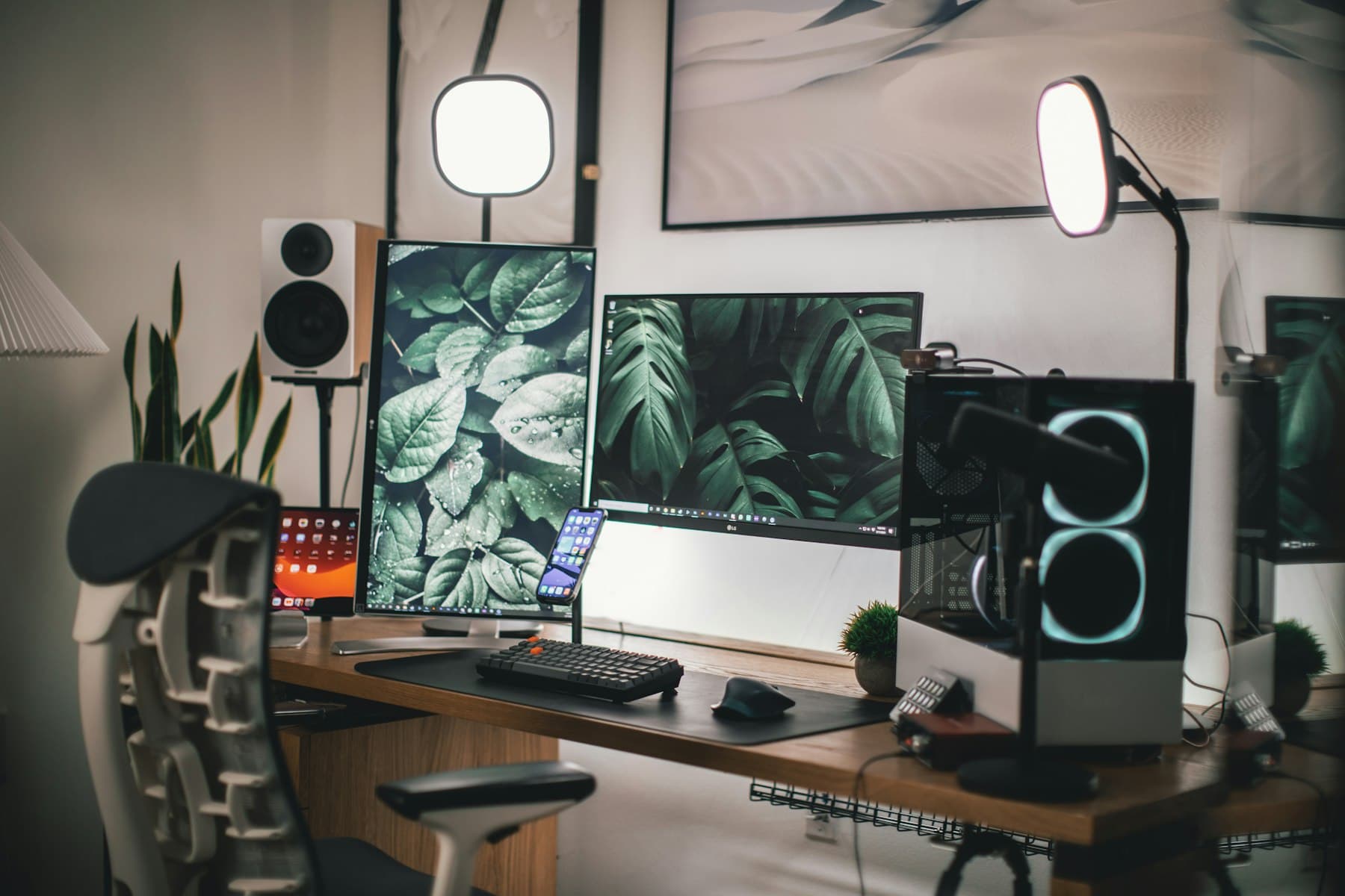 A calm home office desk with a monitor and plants