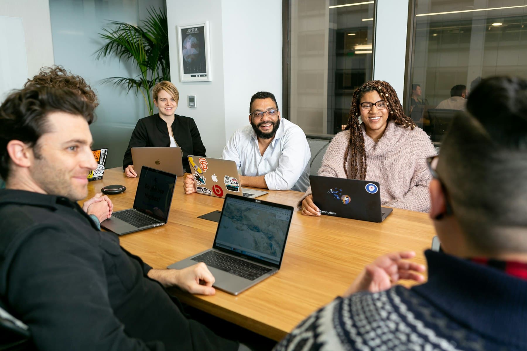 A startup team working on laptops around a meeting table